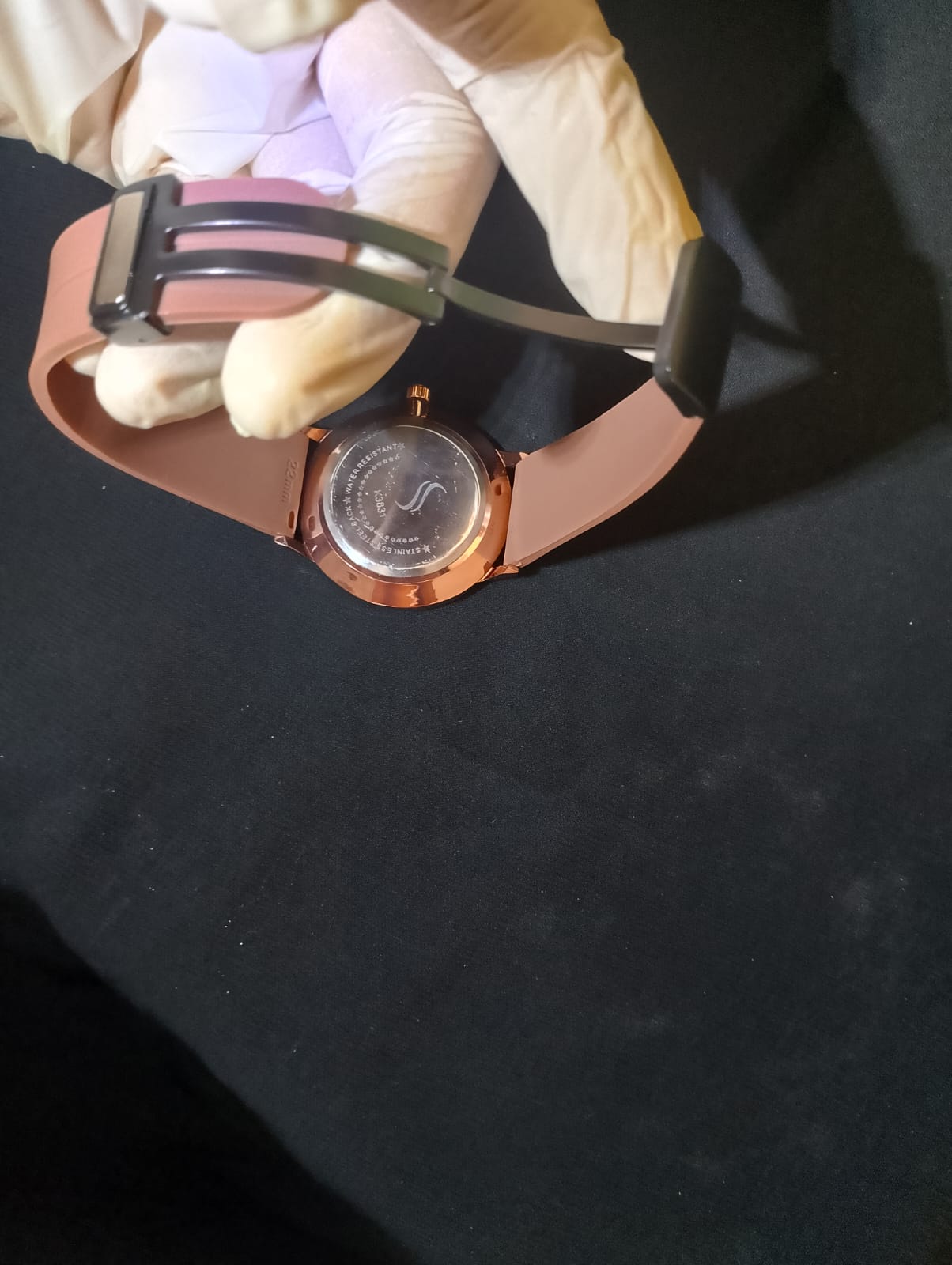 Stylish timepiece with a rose gold case, a white dial, and brown strap.