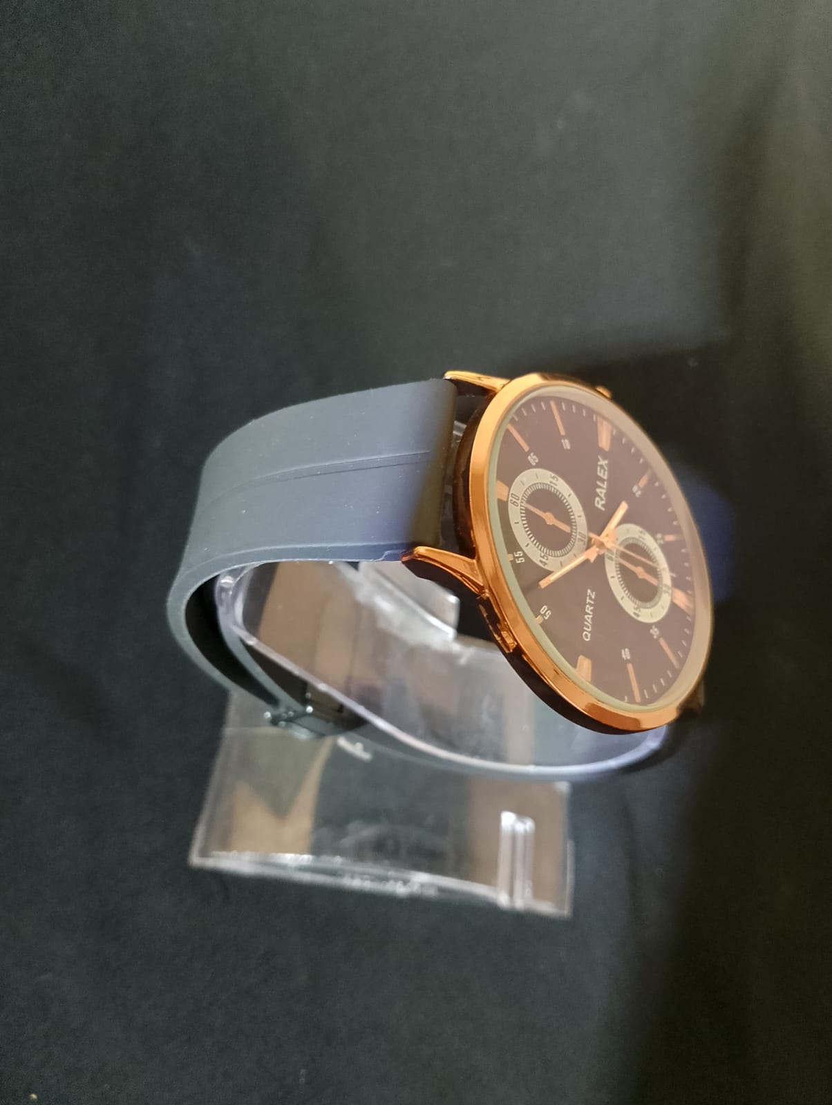 Stylish timepiece with a rose gold case, a black dial, and a black strap.