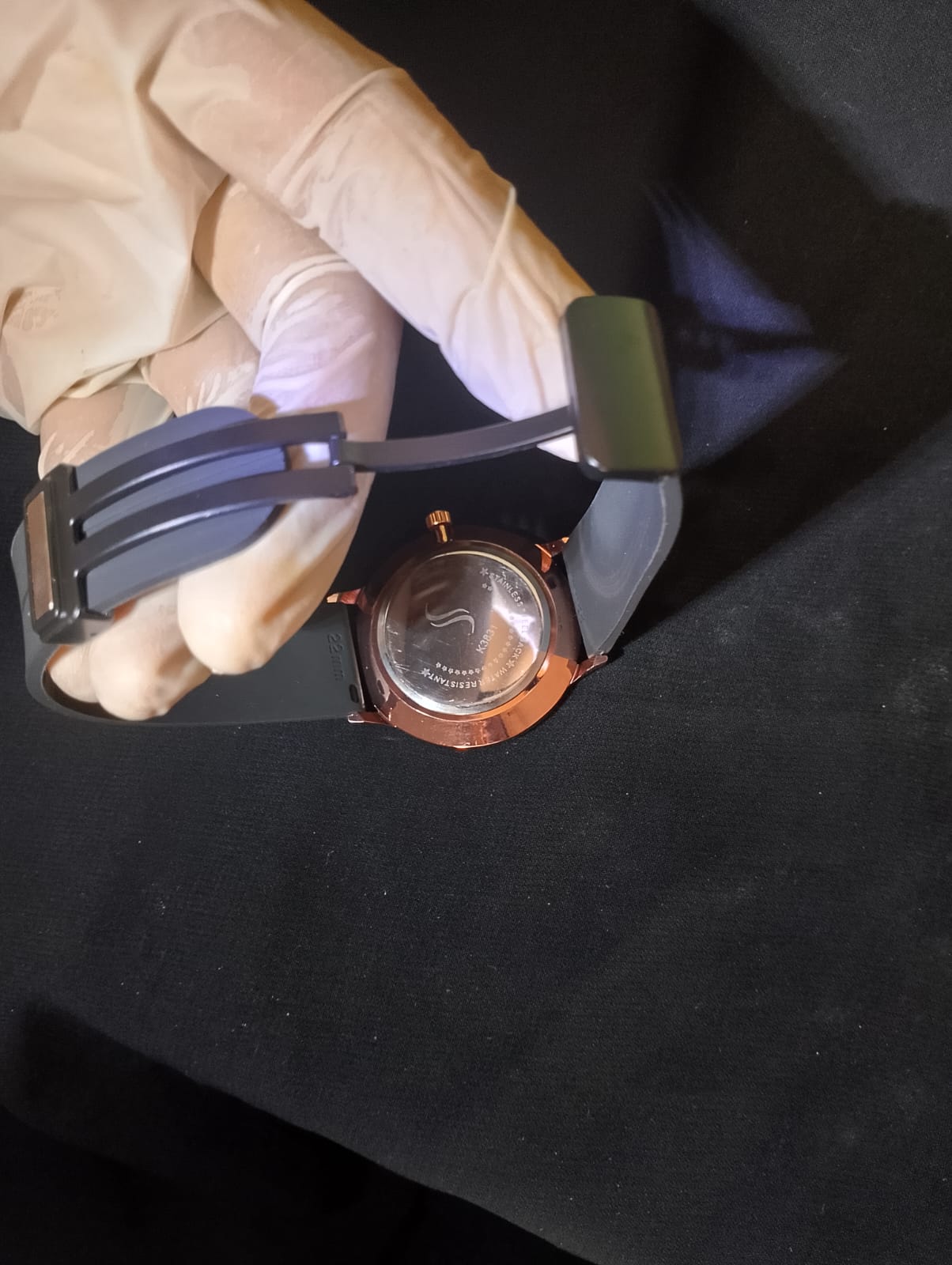 Stylish timepiece with a rose gold case, a black dial, and a black strap.