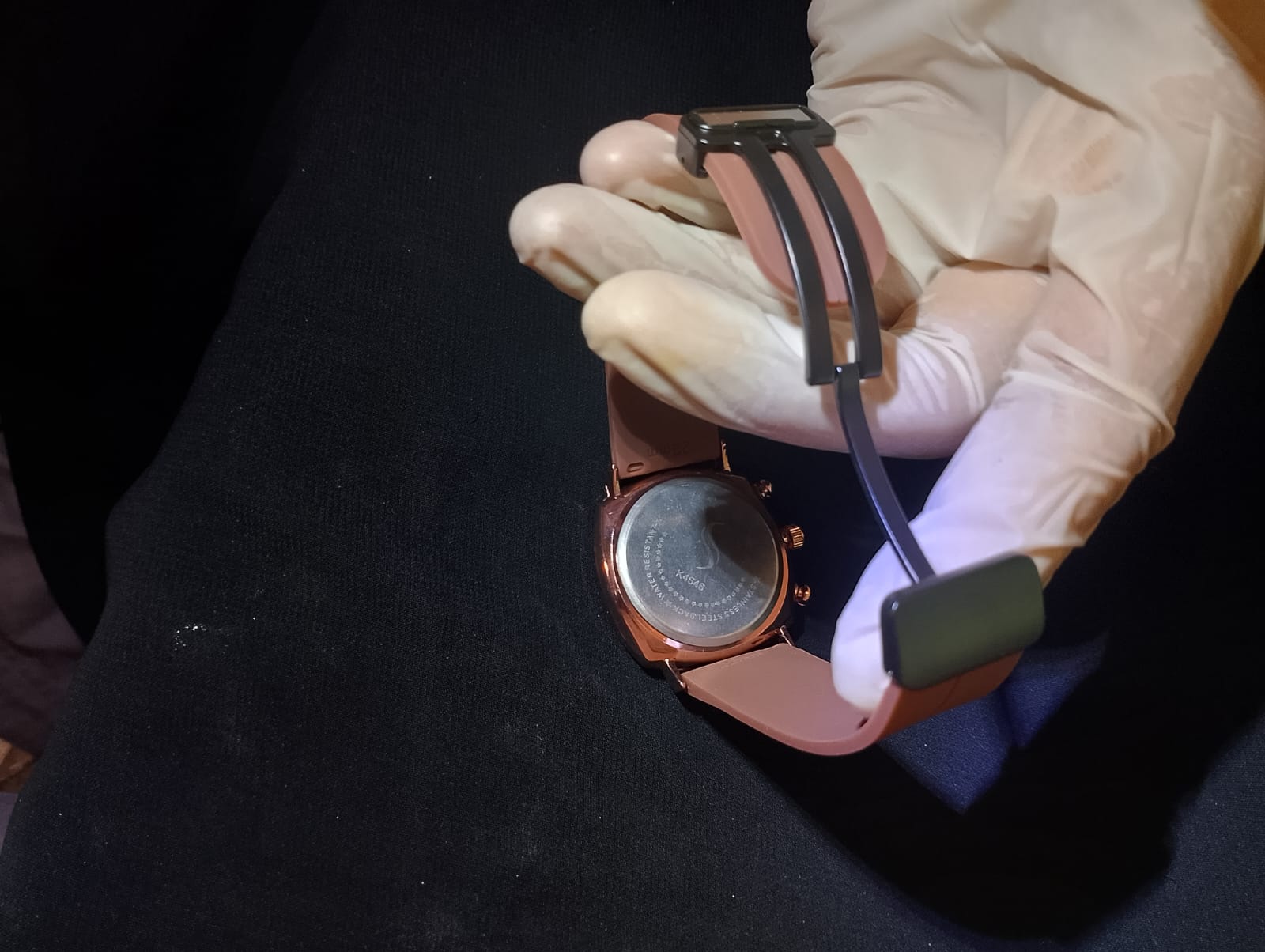 Ralex brand wrist watch with a brown silicone strap and a rose gold-toned case.