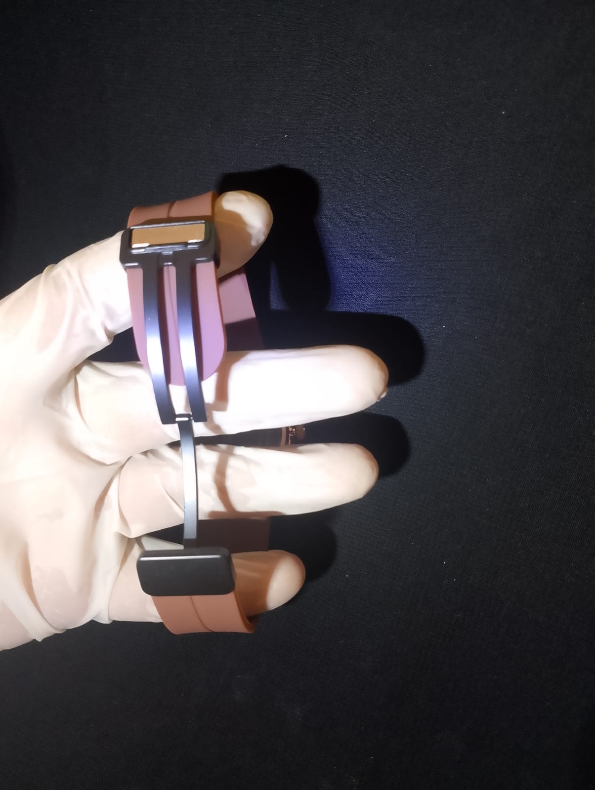 Ralex brand wrist watch with a brown silicone strap and a rose gold-toned case.